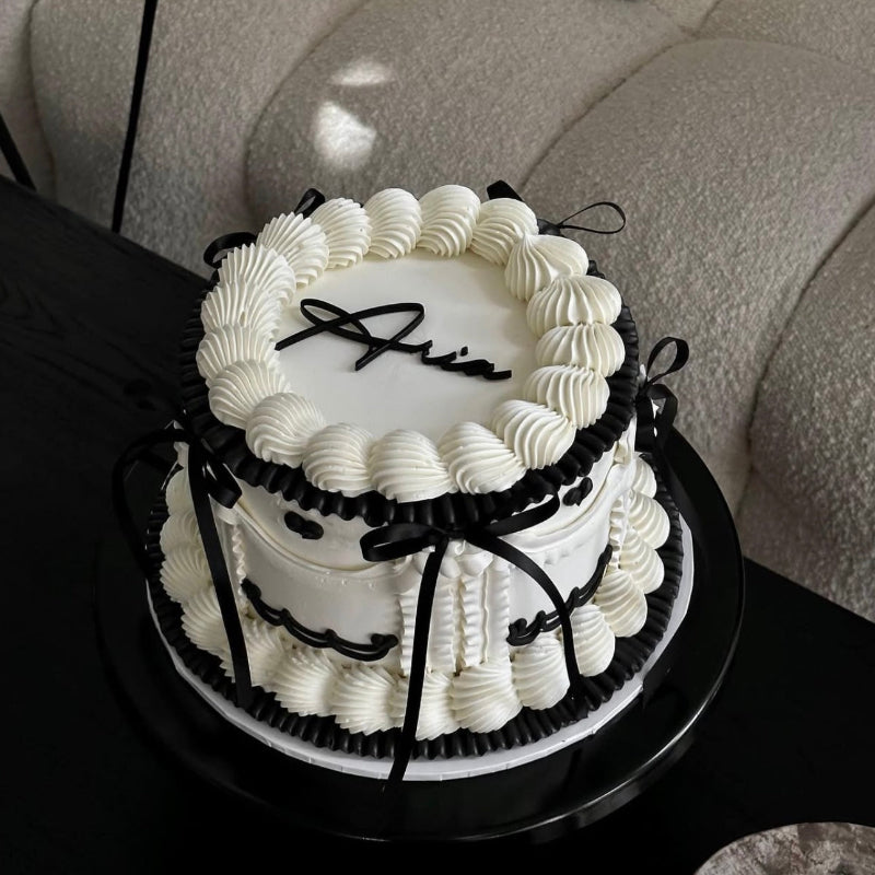 black and white vintage birthday cake in a home setting.