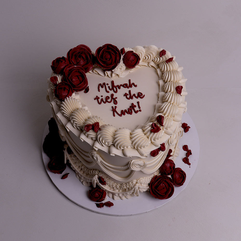 Heart-shaped wedding cake with red buttercream roses, ivory piping and vintage-style ruffles – luxury wedding cake in Melbourne