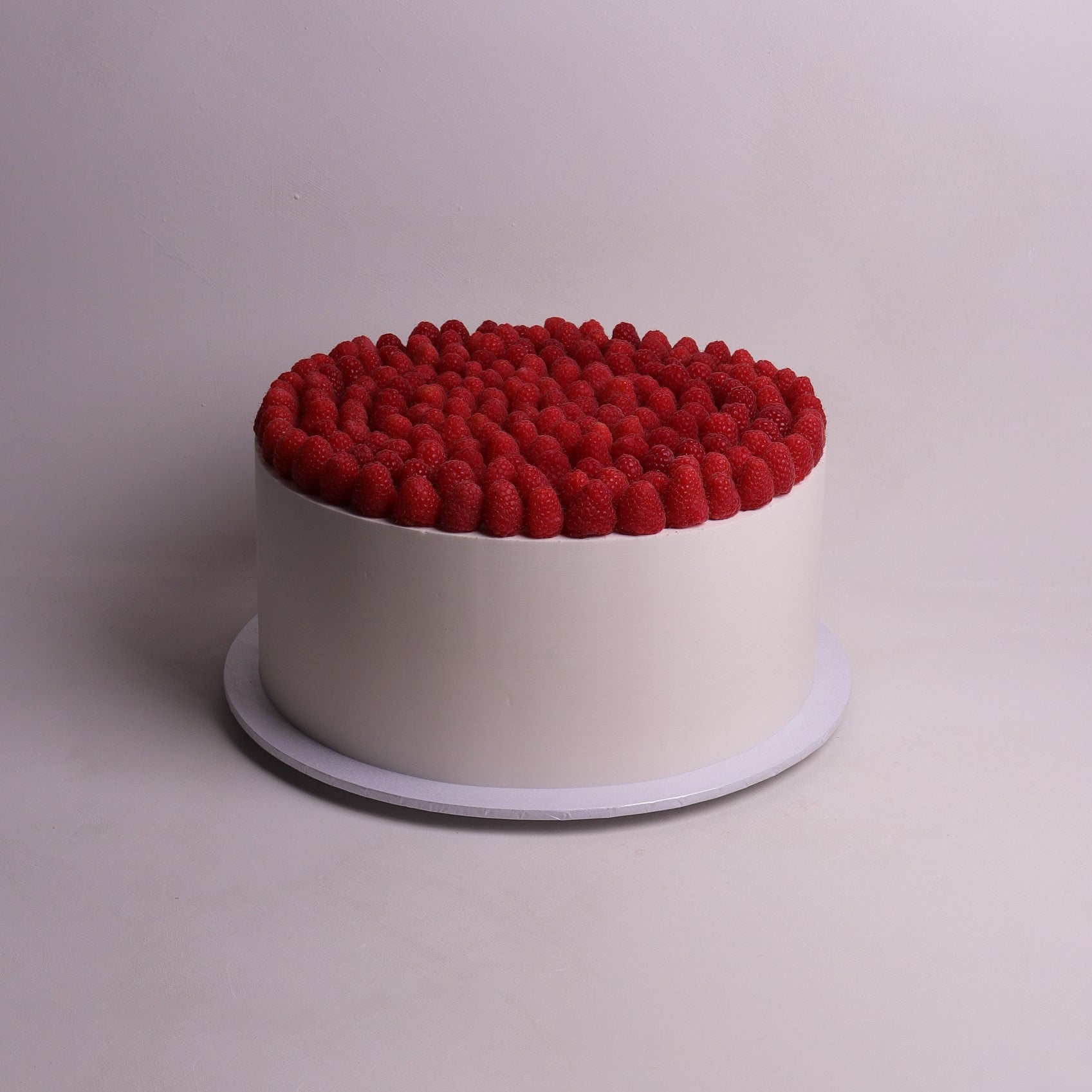 White buttercream cake with fresh raspberries for melbourne wedding