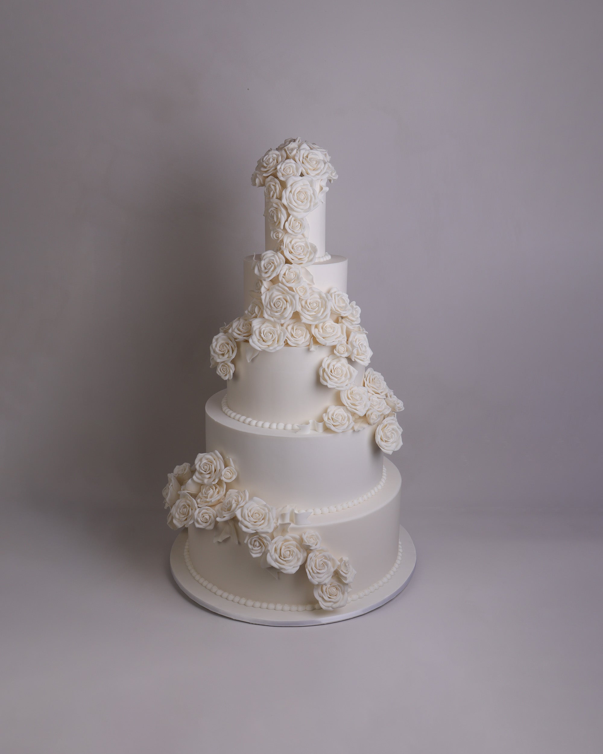 traditional white wedding cake with white sugar flower decorations created in Melbourne. 